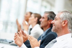 Happy business team applauding together